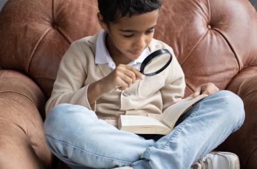 Child with magnifying glass